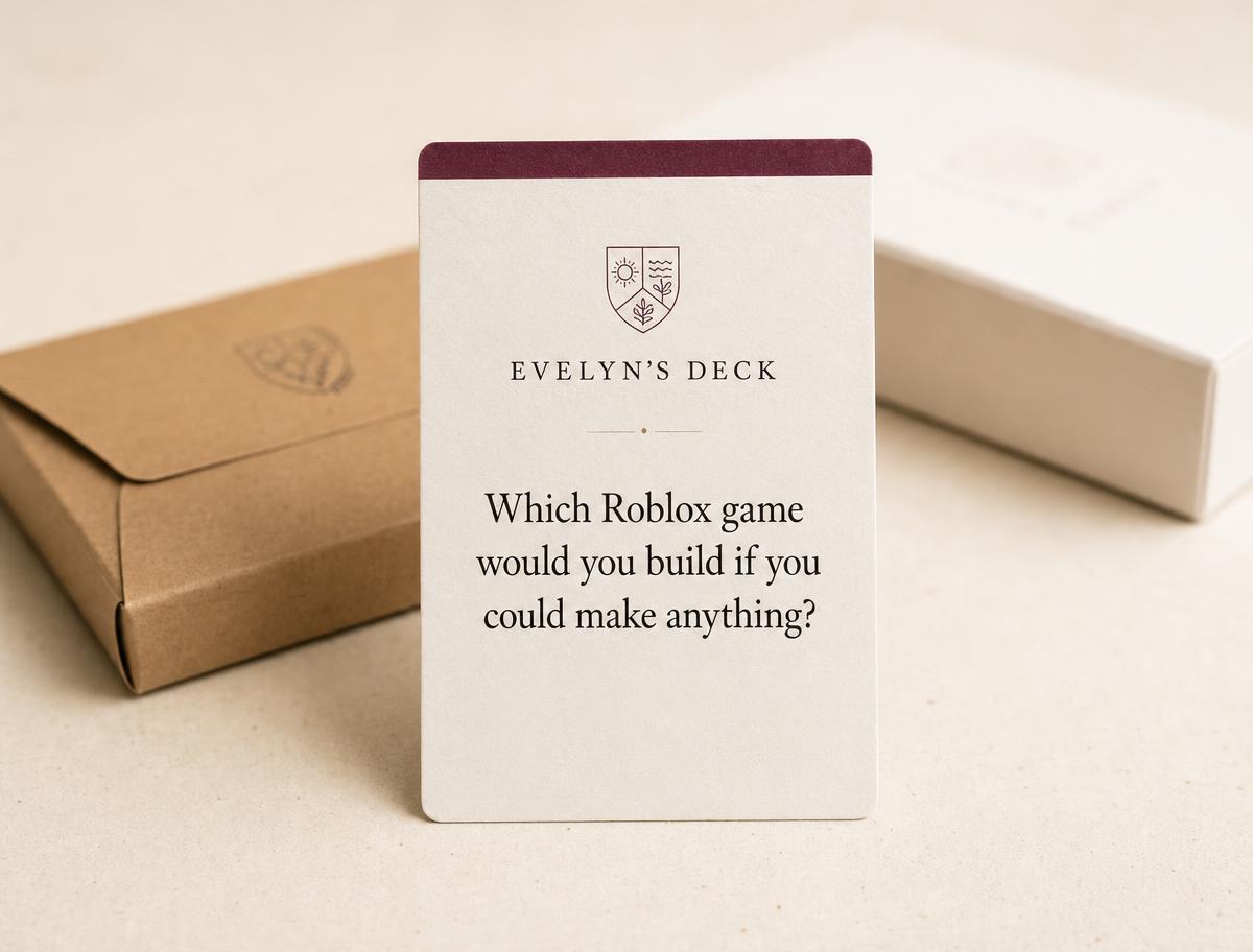 A custom card deck being assembled by hand on a wooden desk.